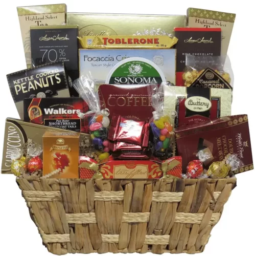 Un panier cadeau gourmand et chocolaté contenant du fromage, des chocolats fins, du café et des collations | A gourmet and chocolate gift basket containing cheese, fine chocolates, coffee, and snacks